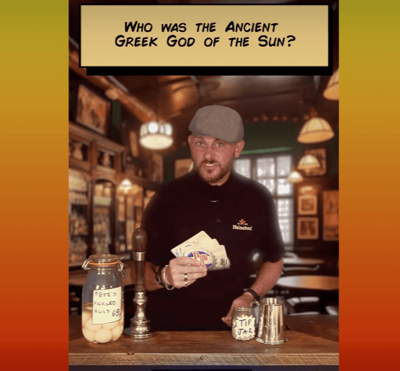 Pub quiz host Pete behind the bar asking, 'Who was the Ancient Greek God of the Sun?'